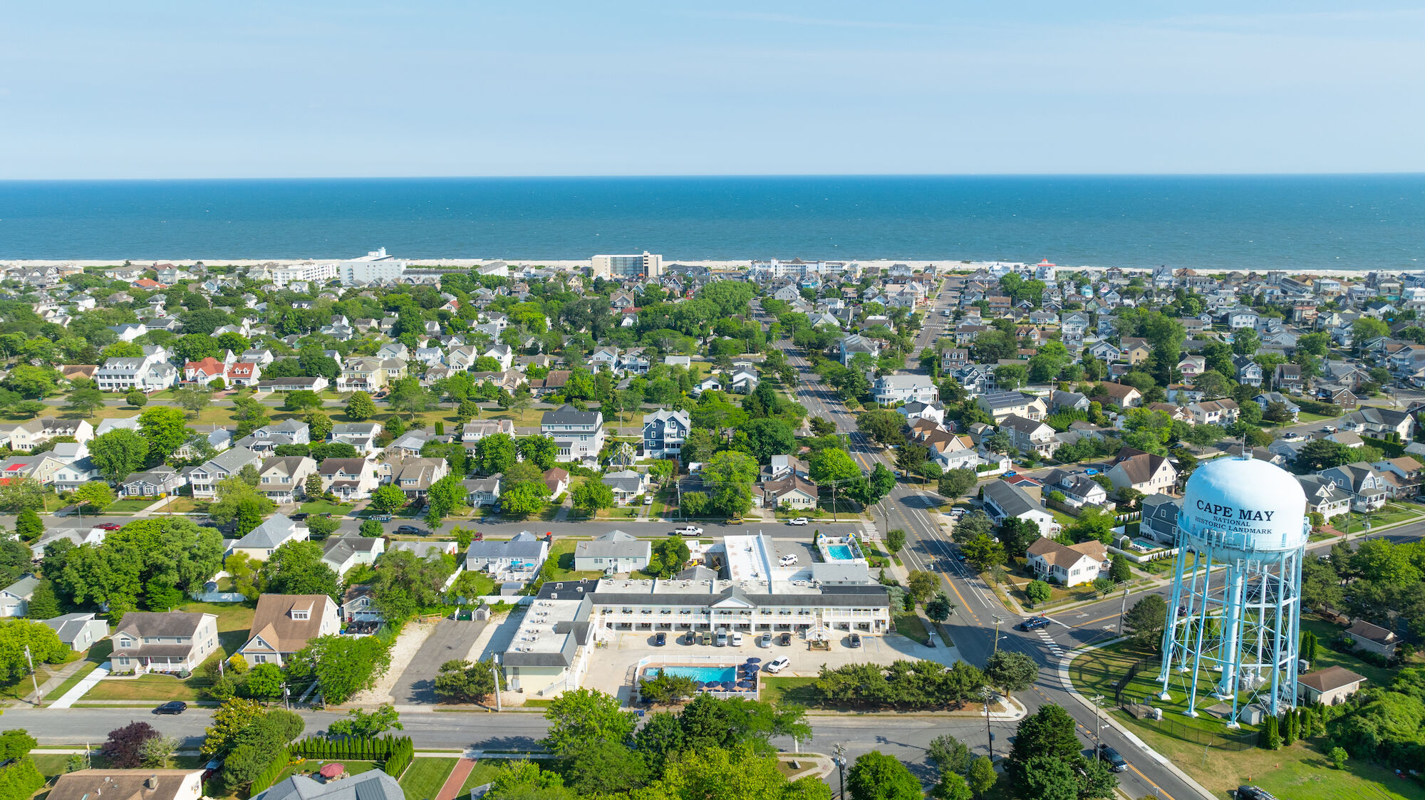 An aerial view of a coastal town with many houses, a water tower labeled 