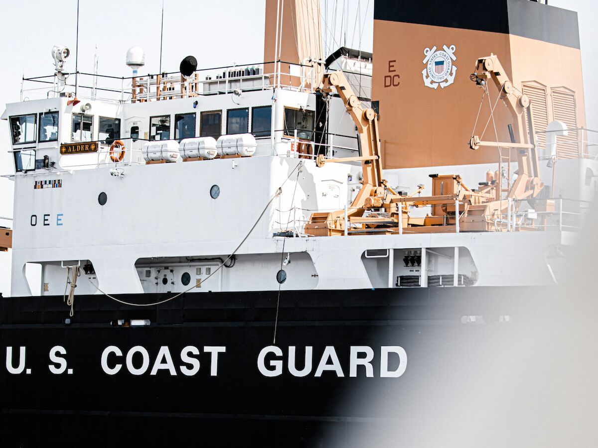The image shows a U.S. Coast Guard ship on the water.